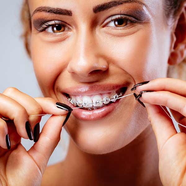 How to floss your teeth with braces